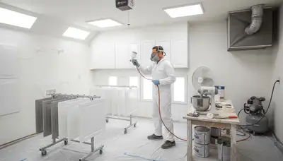 Professional cabinet painting process in Arlington, TX kitchen using spray for smooth, durable finish