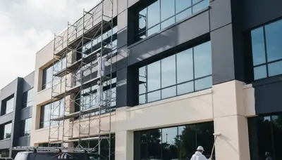 Professional commercial painters in Arlington TX applying durable exterior paint to business building