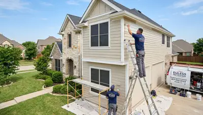 Professional house painters improving home exterior in Arlington, TX